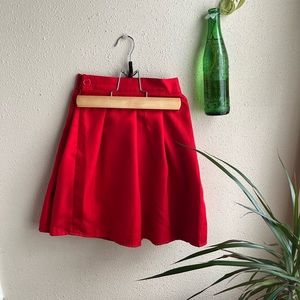 red pleated mini skirt